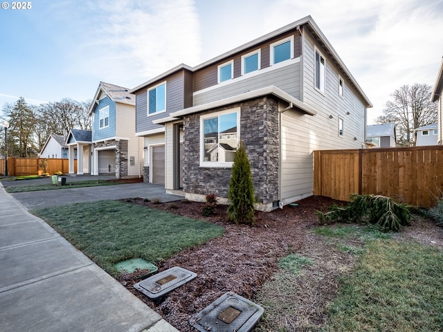 view of front of home with a garage and a front lawn