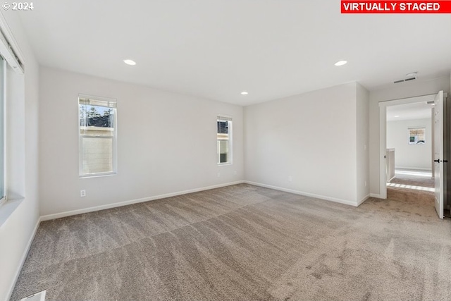 empty room featuring light colored carpet