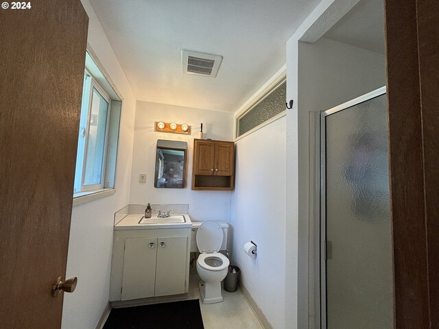 bathroom with vanity, toilet, and walk in shower