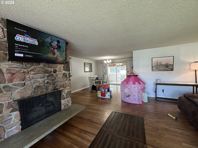 living room featuring a fireplace, dark wood-type flooring, and a textured ceiling