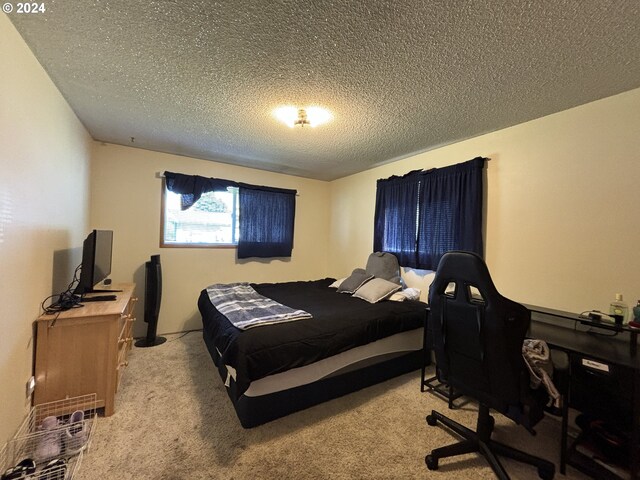 carpeted bedroom with a textured ceiling