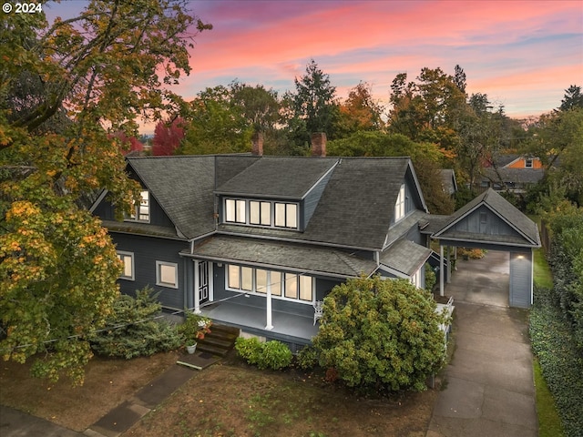 view of front of property with a porch, an outbuilding, and a garage