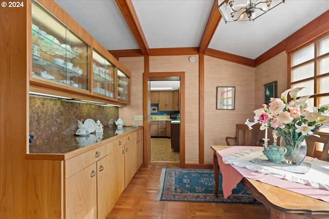 interior space featuring vaulted ceiling with beams, an inviting chandelier, and light parquet flooring