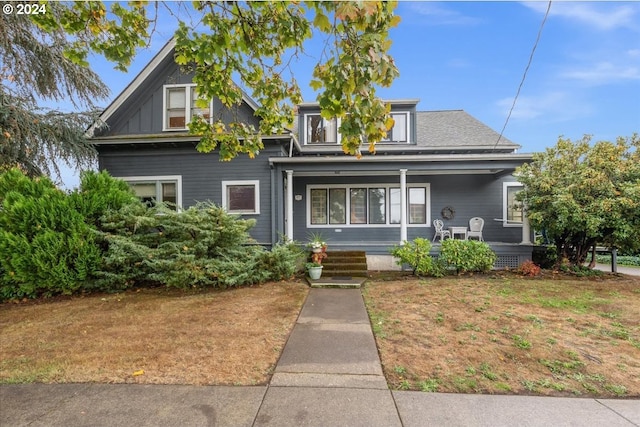 view of front of home with a front lawn and a porch