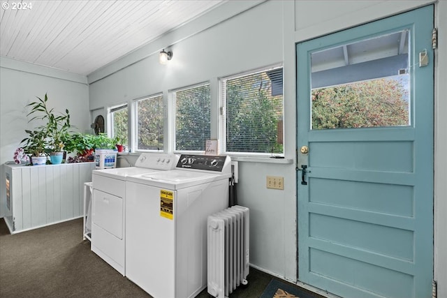 laundry area featuring wood ceiling, dark carpet, radiator, and washing machine and clothes dryer