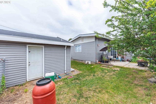 view of yard with a patio area and an outdoor fire pit