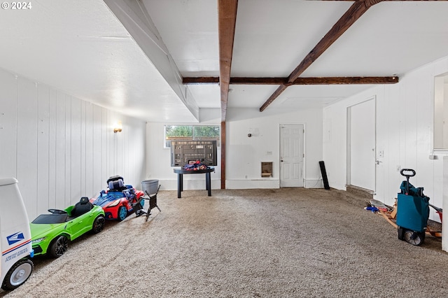 interior space featuring wood walls, beam ceiling, carpet floors, and coffered ceiling