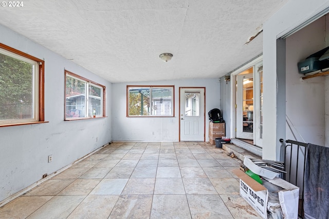 entrance foyer featuring light tile patterned flooring and a textured ceiling