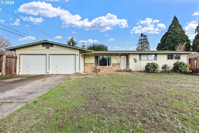 ranch-style home featuring a garage and a front lawn