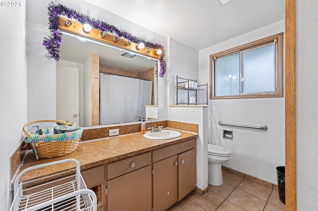 bathroom featuring tile patterned flooring, a shower with curtain, vanity, and toilet