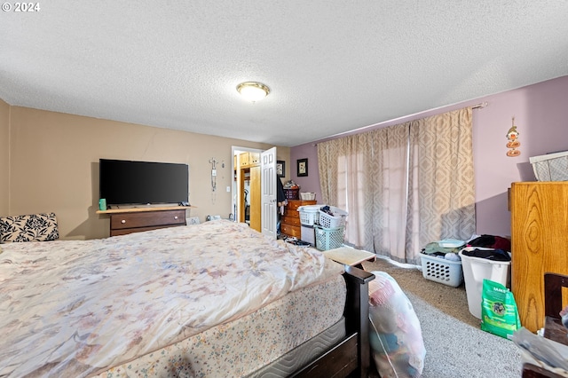 bedroom featuring a textured ceiling and carpet floors