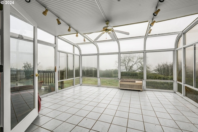 unfurnished sunroom with ceiling fan