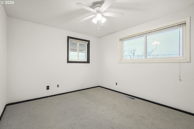 unfurnished room with light carpet and ceiling fan