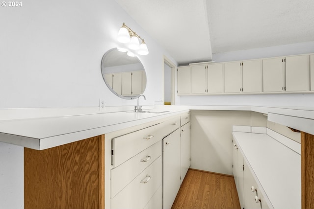 bathroom with hardwood / wood-style floors and sink