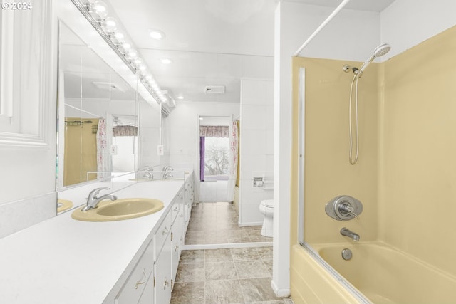 full bathroom featuring tile patterned flooring, vanity, toilet, and tiled shower / bath