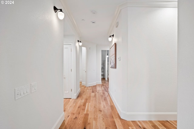 hallway with light wood-style flooring and baseboards