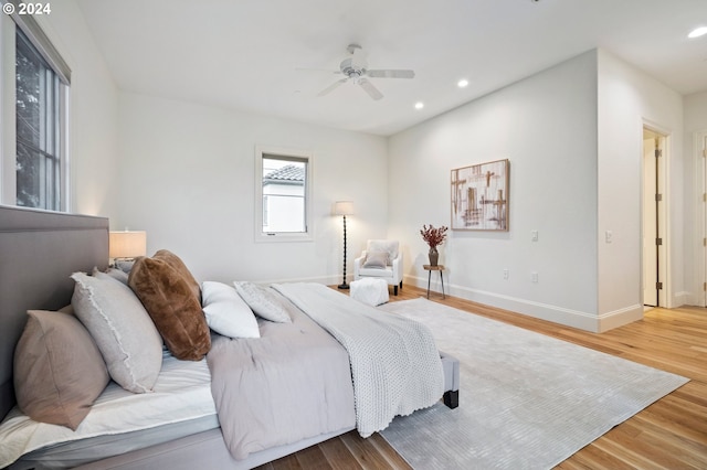 bedroom featuring ceiling fan, recessed lighting, wood finished floors, and baseboards