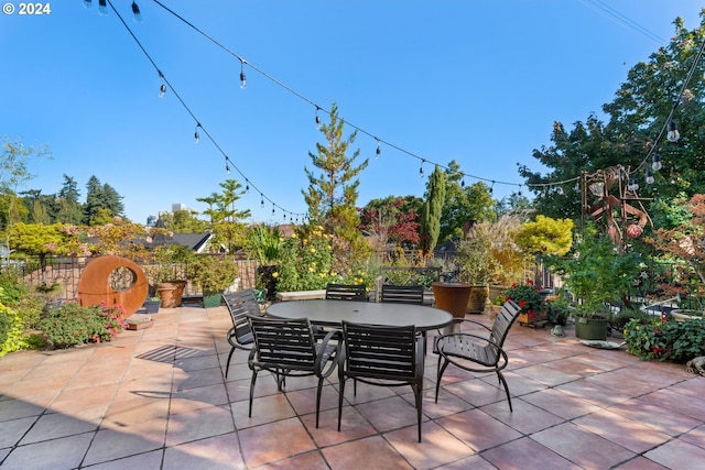 view of patio featuring fence and outdoor dining space