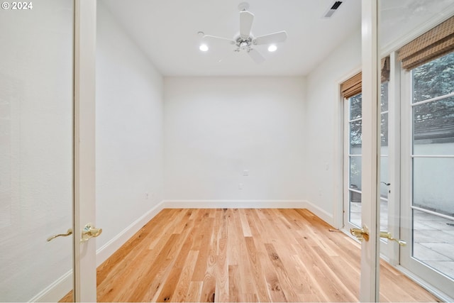 unfurnished room with french doors, visible vents, baseboards, and wood finished floors