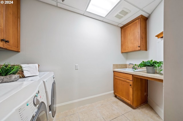 washroom featuring light tile patterned floors, separate washer and dryer, a sink, visible vents, and cabinet space