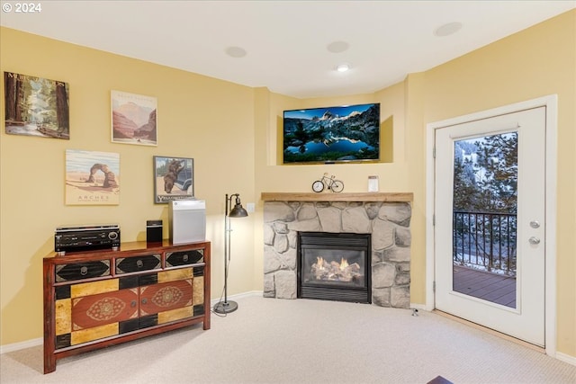 carpeted living room featuring a fireplace