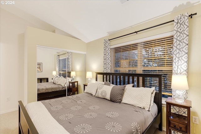 bedroom with carpet floors and vaulted ceiling