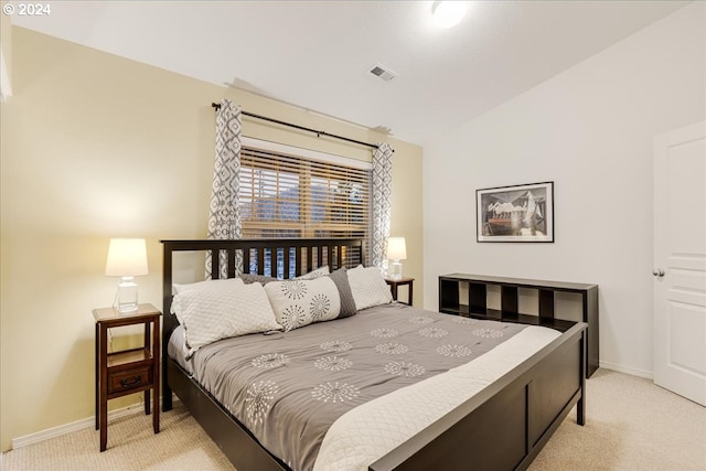 carpeted bedroom with vaulted ceiling