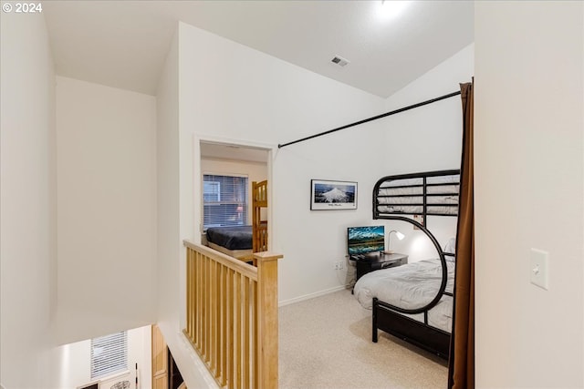 corridor featuring carpet and lofted ceiling