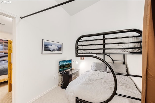 carpeted bedroom featuring lofted ceiling