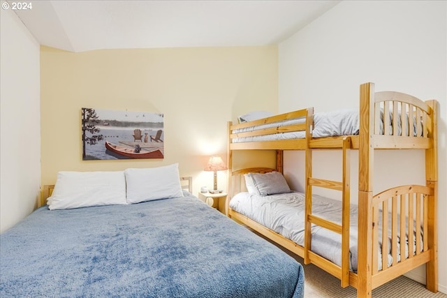 carpeted bedroom featuring lofted ceiling