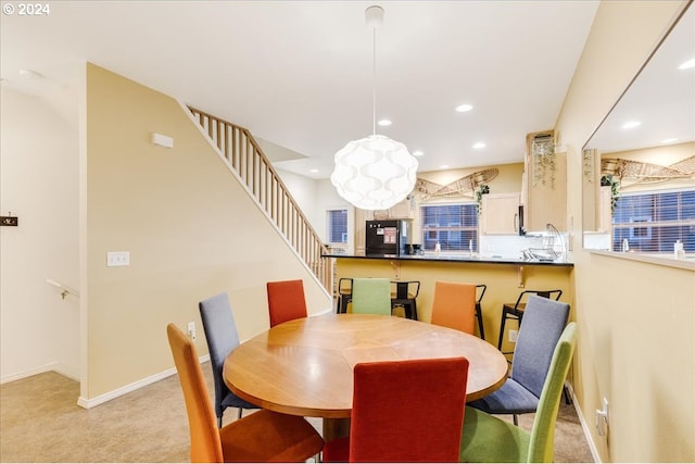 dining space with light colored carpet