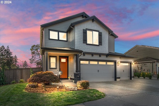 view of front of house featuring a yard and a garage