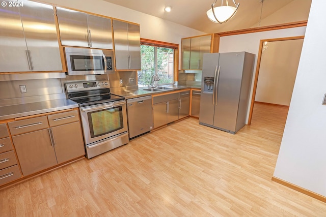3794 Wilshire Ln, Eugene, OR 97405 - kitchen featuring stainless steel counters, stainless steel appliances, a sink, light wood finished floors, and vaulted ceiling