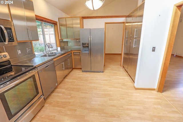 3794 Wilshire Ln, Eugene, OR 97405 - kitchen featuring stainless steel appliances, a sink, light wood finished floors, lofted ceiling, and stainless steel counters