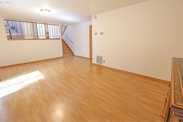 3794 Wilshire Ln, Eugene, OR 97405 - empty room featuring light wood-style flooring, stairway, and baseboards