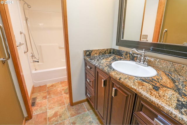 3794 Wilshire Ln, Eugene, OR 97405 - bathroom featuring vanity, stone finish floors, shower / bath combination, and baseboards