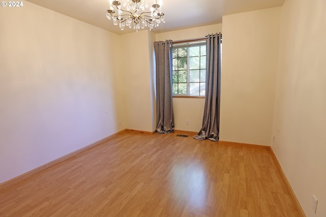3794 Wilshire Ln, Eugene, OR 97405 - spare room with a chandelier, light wood-style flooring, and baseboards
