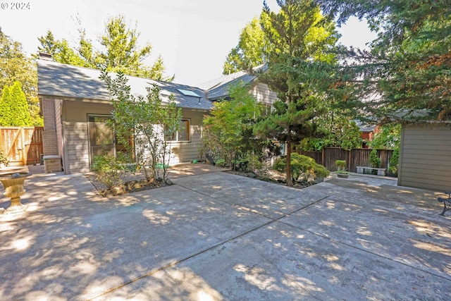 3794 Wilshire Ln, Eugene, OR 97405 - view of front of home with a patio, fence, and a chimney