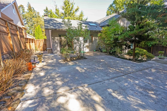 3794 Wilshire Ln, Eugene, OR 97405 - view of front of house with fence, a patio, and a chimney
