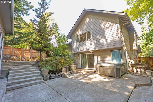 3794 Wilshire Ln, Eugene, OR 97405 - back of house featuring a patio, fence, and a hot tub