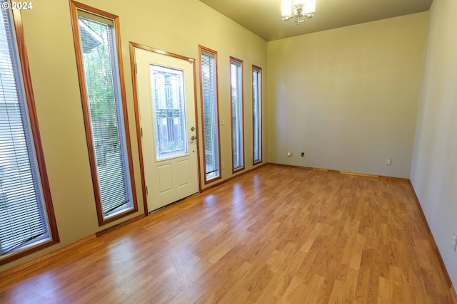 3794 Wilshire Ln, Eugene, OR 97405 - unfurnished room with light wood-style flooring, a chandelier, and baseboards