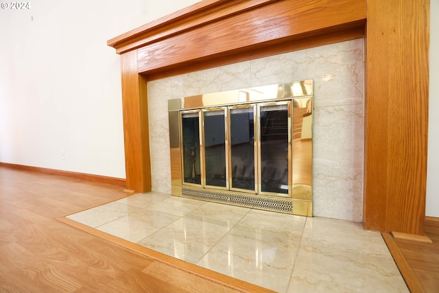 interior details with hardwood / wood-style flooring and a fireplace