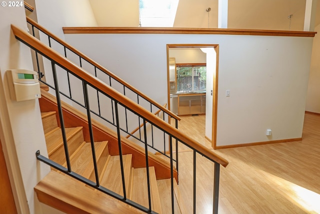 3794 Wilshire Ln, Eugene, OR 97405 - stairway featuring a skylight, wood finished floors, and baseboards