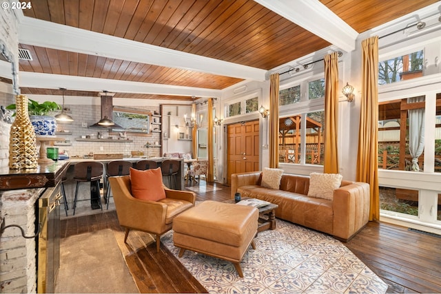 living room with beamed ceiling, light hardwood / wood-style flooring, a wealth of natural light, and wooden ceiling