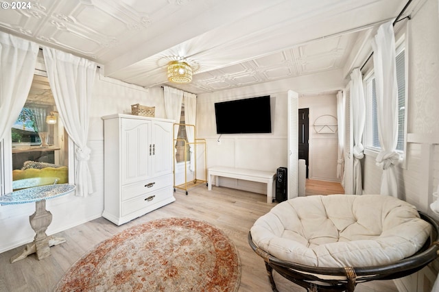 sitting room with a chandelier and light wood-type flooring