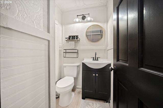 bathroom featuring vanity, toilet, and wood-type flooring