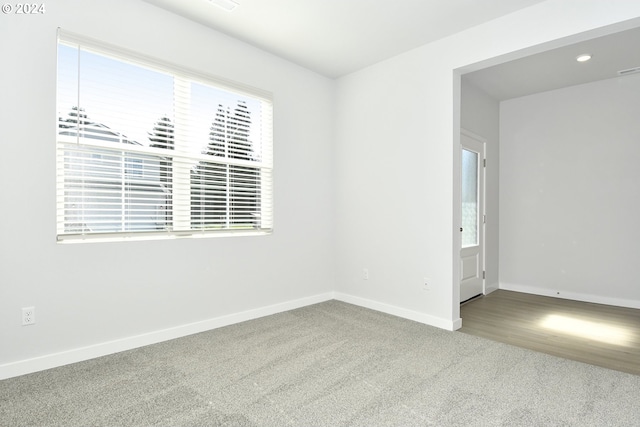 carpeted empty room featuring plenty of natural light