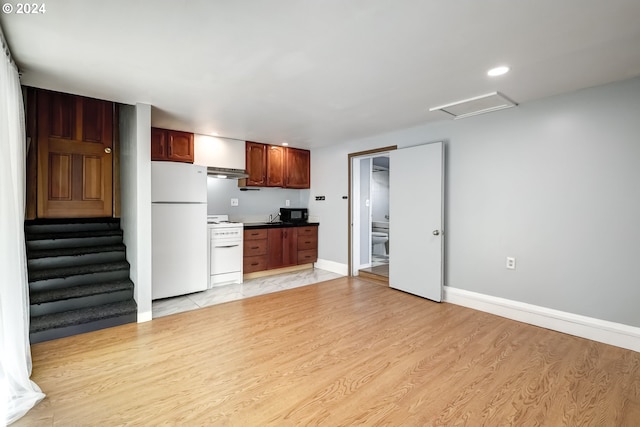 kitchen featuring white appliances, exhaust hood, and light wood-type flooring