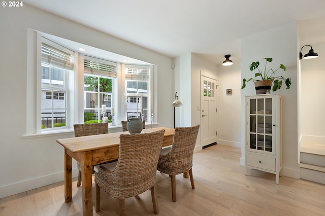 dining space with a healthy amount of sunlight and light hardwood / wood-style flooring