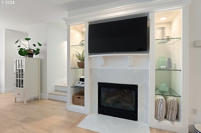 living room with light hardwood / wood-style flooring and a tile fireplace